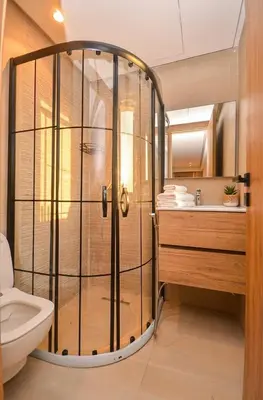 a bathroom with a shower with a toilet and a sink at Studio 01 Maarif - High Speed Wi-Fi in Casablanca