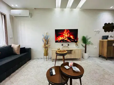 a living room with a couch and a fire on the wall at Studio lumineux pour un séjour agréable 28 in Casablanca