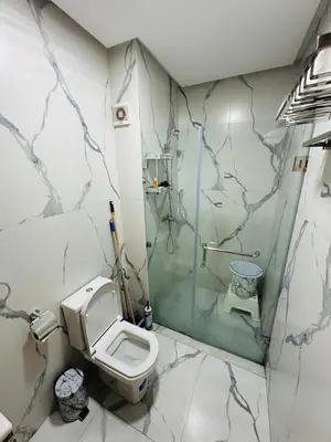 a bathroom with a toilet and a glass shower at Studio lumineux pour un séjour agréable 28 in Casablanca