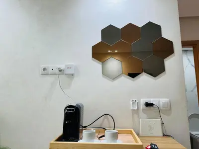 a table with cups and a lamp on a wall at Studio lumineux pour un séjour agréable 28 in Casablanca