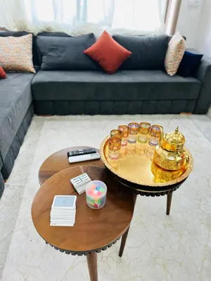 a coffee table with a tray of cupcakes on it in a living room at Studio lumineux pour un séjour agréable 28 in Casablanca