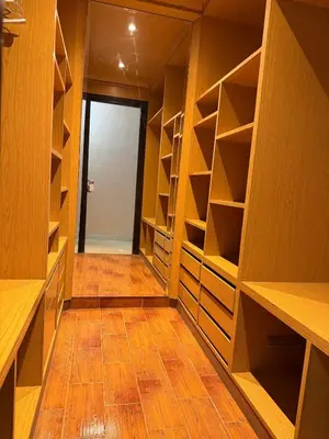 a walk in closet with wooden shelves and a hallway at Grand 3 pièces de standing, confort premium in Casablanca