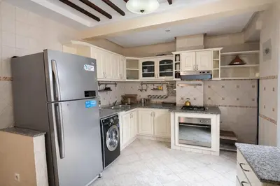a kitchen with a stainless steel refrigerator and a dishwasher at Grand 3 pièces de standing, confort premium in Casablanca