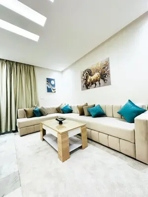 a living room with a couch and a coffee table at Studio cosy et calme, idéal pour se détendre 15 in Casablanca
