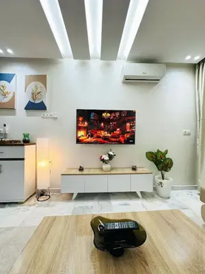 a living room with a tv on the wall at Studio cosy et calme, idéal pour se détendre 15 in Casablanca