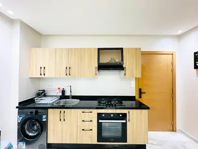 a kitchen with a sink and a stove top oven at Studio cosy et calme, idéal pour se détendre 15 in Casablanca