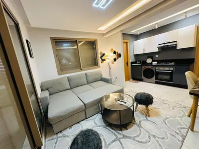 a living room with a couch and a table at Studio tout équipé pour un séjour confortable 22 in Casablanca