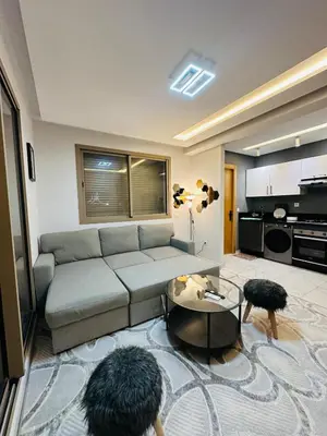 a living room with a couch and a table at Studio tout équipé pour un séjour confortable 22 in Casablanca