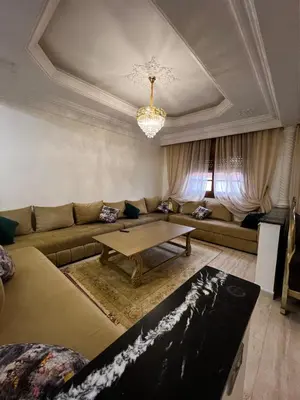a living room with a couch and a table at Appartement confortable à Rabat, idéalement situé près de la Corniche et du Stade in Rabat