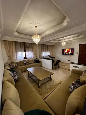 a large living room with couches and a table at Appartement confortable à Rabat, idéalement situé près de la Corniche et du Stade in Rabat