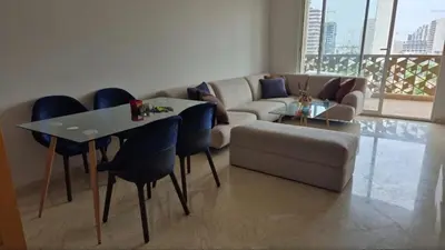 a living room with a couch and a table and chairs at Appartement CFC - Anfasky in Casablanca