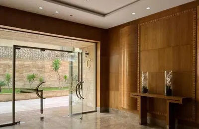 a lobby with a glass door and a table and a window at Appartement CFC - Anfasky in Casablanca