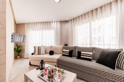 a living room with a couch and a table at Apartment in the center of Casablanca opposite the tram in Casablanca