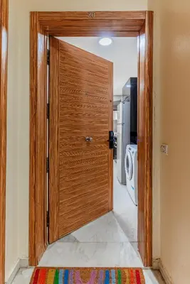 a wooden door in a room with a kitchen at Apartment in the center of Casablanca opposite the tram in Casablanca