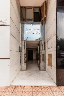 an entrance to a building with a sign that reads residence delving at Apartment in the center of Casablanca opposite the tram in Casablanca