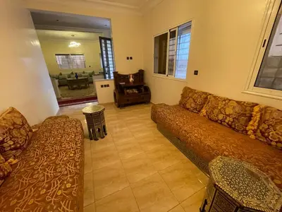 a living room with a couch and a table at Large Villa Pool And Garden on 5200 m in Berrechid