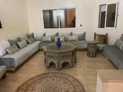 a living room with a couch and a table at Large Villa Pool And Garden on 5200 m in Berrechid