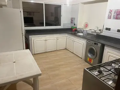 a kitchen with white cabinets and a washer and dryer at Large Villa Pool And Garden on 5200 m in Berrechid