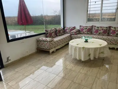 a living room with a couch and a table at Large Villa Pool And Garden on 5200 m in Berrechid