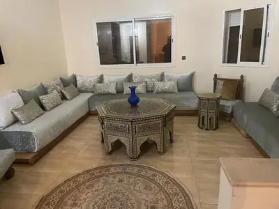 a living room with a couch and a table at Large Villa Pool And Garden on 5200 m in Berrechid