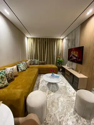 a living room with a couch and a table at Beau Living Park Residence Bright Central Cosy Apartment Beauséjour Centre De Casablanca En Face De Anfa Park in Casablanca
