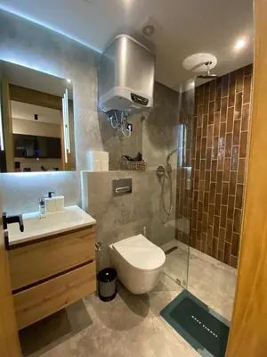 a bathroom with a toilet and a sink and a shower at Beau Living Park Residence Bright Central Cosy Apartment Beauséjour Centre De Casablanca En Face De Anfa Park in Casablanca