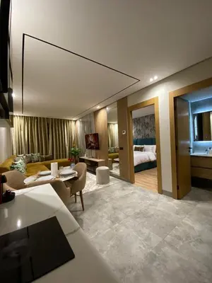 a living room with a couch and a bedroom at Beau Living Park Residence Bright Central Cosy Apartment Beauséjour Centre De Casablanca En Face De Anfa Park in Casablanca