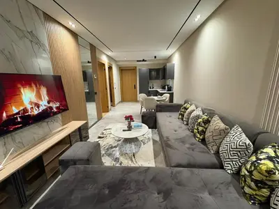a living room with a couch and a fireplace at Beau Living Residence Central Cosy Apartment In The Heart Of Casablanca Close To Anfa Park Calm Area in Casablanca