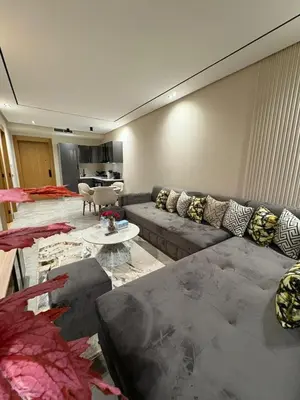a living room with a couch and a table at Beau Living Residence Central Cosy Apartment In The Heart Of Casablanca Close To Anfa Park Calm Area in Casablanca