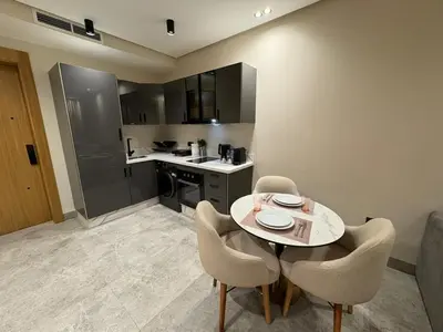 a kitchen with a table and chairs in a room at Beau Living Residence Central Cosy Apartment In The Heart Of Casablanca Close To Anfa Park Calm Area in Casablanca