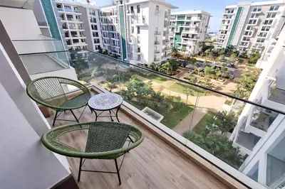 a balcony with two chairs and a table at Central Modern Apartment Agdal TGV Train Station in Rabat