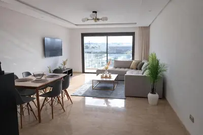 a living room with a couch and a table at Central Modern Apartment Agdal TGV Train Station in Rabat