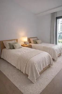 two beds in a white bedroom with a window at Central Modern Apartment Agdal TGV Train Station in Rabat