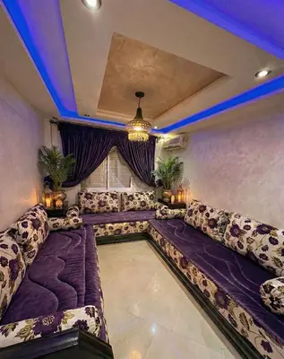 a living room with couches and a ceiling with blue lights at Séjour économique près de la plage in Bouznika