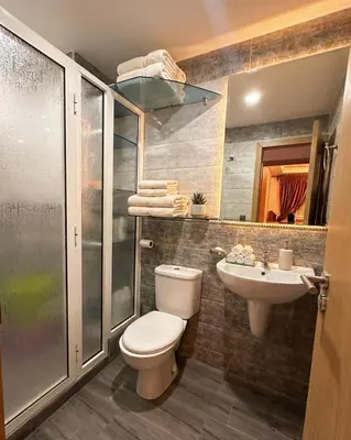 a bathroom with a toilet and a sink and a shower at Séjour économique près de la plage in Bouznika