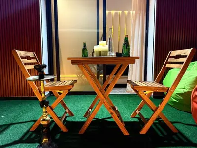 a table and two chairs with bottles on a balcony at Business Executive Apartment Central Casablanca in Casablanca