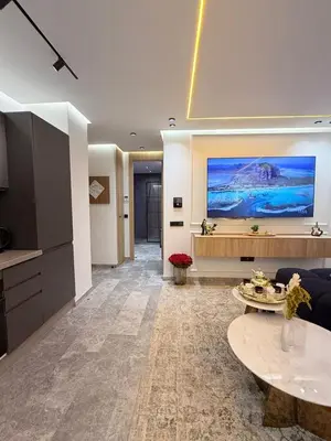 a living room with a large tv on the wall at Business Executive Apartment Central Casablanca in Casablanca