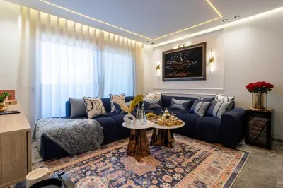 a living room with a blue couch and a table at Business Executive Apartment Central Casablanca in Casablanca