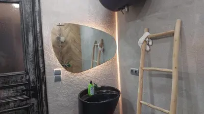 a bathroom with a sink and a mirror at Cocon & Confort in Dar Ben Abdallah Ben Dehbi