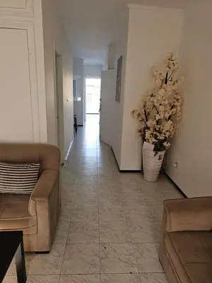 a living room with a couch and a vase of flowers at Superbe studio a avenue france agdal in Rabat