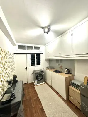 a kitchen with white cabinets and a stove at appartement au coeur de Rabat in Rabat