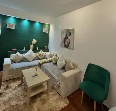 a living room with a couch and a chair at appartement au coeur de Rabat in Rabat