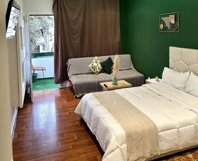 a green bedroom with a bed and a couch at appartement au coeur de Rabat in Rabat