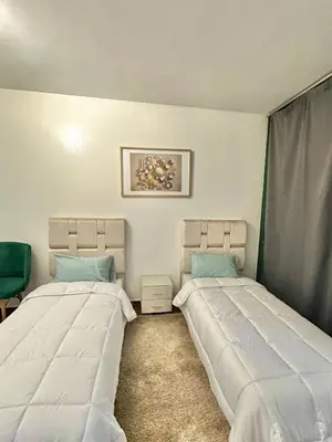 two beds sitting next to each other in a room at appartement au coeur de Rabat in Rabat