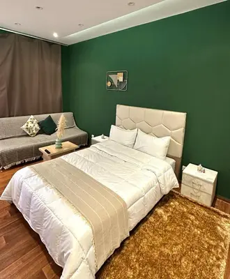 a bedroom with a large bed and a couch at appartement au coeur de Rabat in Rabat