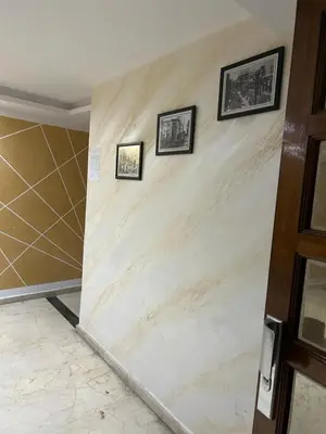 a room with three framed pictures on a wall at Rihab's House in Casablanca