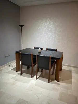 a dining room table with chairs and a black table at Rihab's House in Casablanca