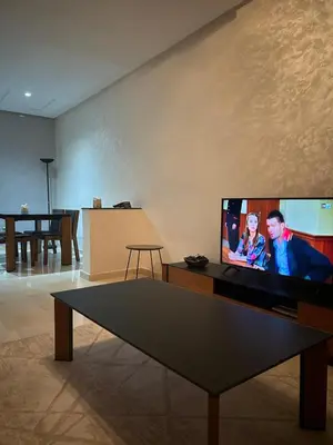 a living room with a flat screen tv on a wall at Rihab's House in Casablanca