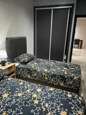 two beds sitting in a room with stars at Rihab's House in Casablanca