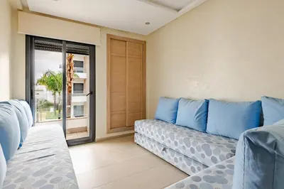 a living room with a couch and a window at Cosy 2 Bedrooms Skhirat Residence in Skhirat